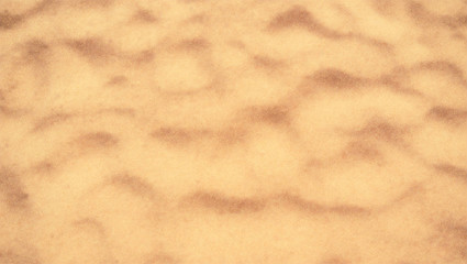 Sand on the beach, top view. Blurred background. Sand with dunes on tropical beach. Defocused vector background, EPS10.