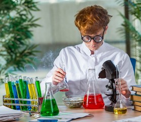Young crazy chemist working in the lab