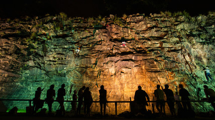 rock climbing night time on the cliff wall assistant people silhouette Brisbane Australia Kangaroo...