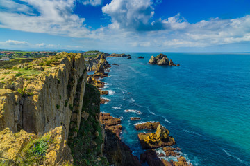 Incredible cliffs on the coast near the village of Liencres. Cantabria. Northern coast of Spain