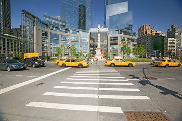 Yellow cabs and taxies speed by Columbus Circle, Manhattan, New York City, New York