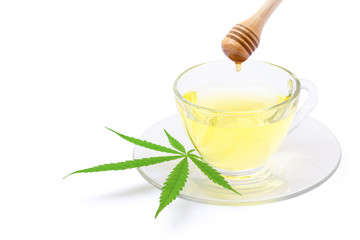 Cup of cannabis tea isolated on white