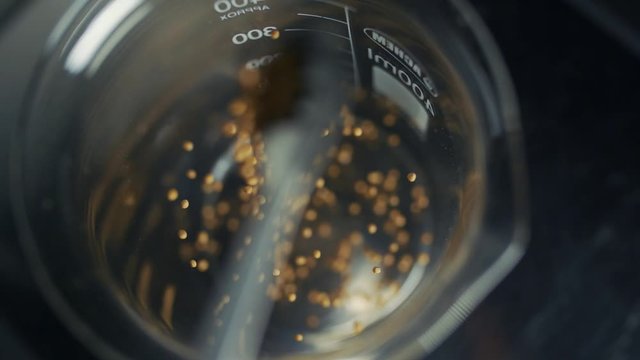 seeds are emptied into beaker. jump of seeds.1