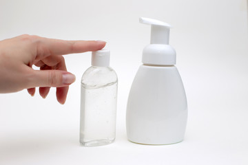 Hand on a white background with a white bottle of antibacterial soap