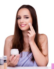 Woman doing makeup isolated on white