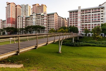 Buildings and a foot bridge behind the park