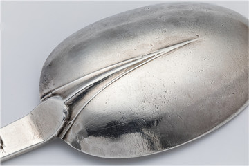 Macro close up of the rat tail design on the bowl of a trifid or trefid spoon dated 1687.