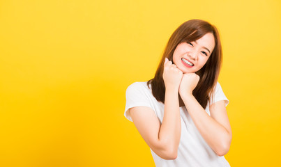 woman teen stand wear t-shirt happy expression fist pressed together under chin