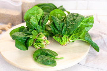 Close-up of spinach on the kitchen table on a light background