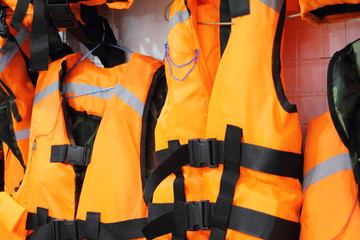 Bright marine life vest jackets close up, safety on water tourism activity and watersports