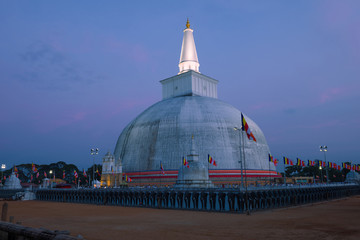 View of the old Ruwanweli Maha Seya dagoba in the evening twilight. Anuradhapura, Sri Lanka
