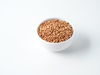 Plate with buckwheat isolated on white background.