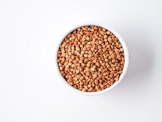 Plate with buckwheat isolated on white background.