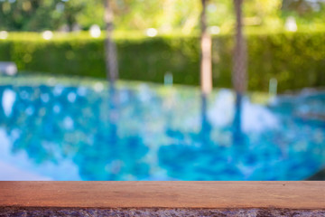 display products on the table, background beside the pool behind the accommodation