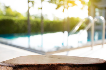 display products on the table, background beside the pool behind the accommodation