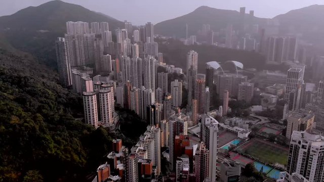 Aerial sweeping pan of skyscrapers on a mountain