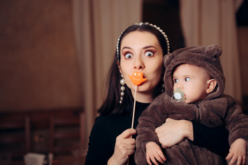 Funny Mother with Party Accessory Holding Baby