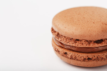 Chocolate macaroni cookies on a white background with brown filling, isolated.