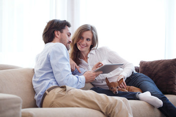 Couple at home with pet dog