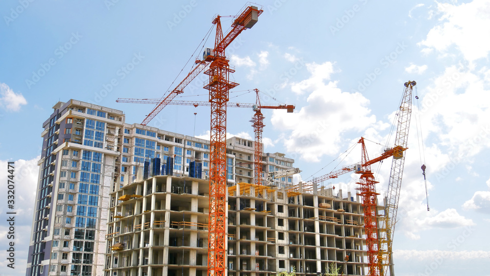 Wall mural construction site with tower cranes and buildings. construction of a skyscraper.