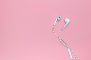 White Earphons on pink background.