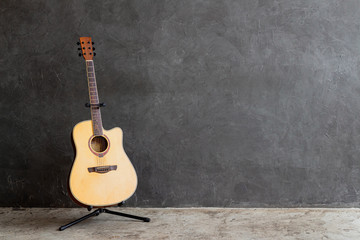 acoustic guitar on gray wall background