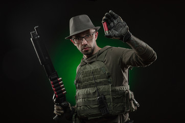 Fototapeta premium an athletic guy with a tattoo poses with a shotgun