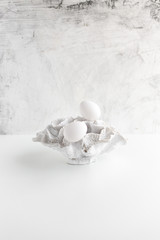 white eggs and coral on a white background with copy space