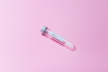 Pandemic minimal creative concept. COVID-19 test and empty laboratory sample for diagnosis new Coronavirus infection on pink background.