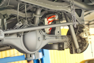 Pickup car independent suspension system, double wishbone, shock absorber and coil spring,Car suspension on lifter in car service.Close up.