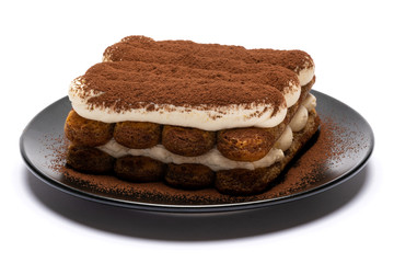 Classic tiramisu dessert on ceramic plate isolated on white background with clipping path