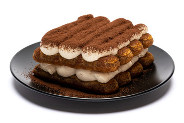 Classic tiramisu dessert on ceramic plate isolated on white background with clipping path