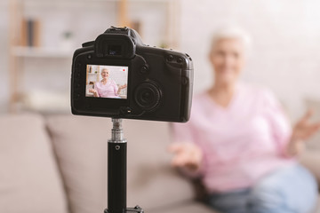 Senior woman blogger recording video vlog at home