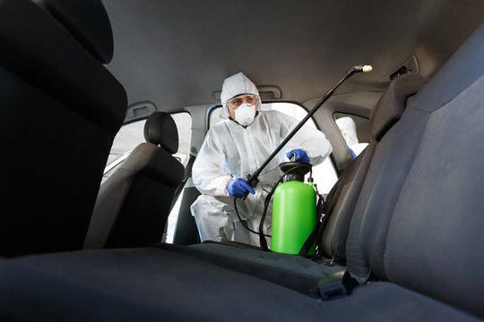 Hot Steam Disinfection Of Car Seats In Coronavirus Hazmat