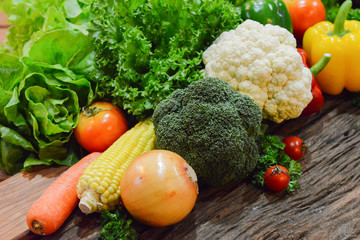 Mixed Vegetables and Salads on wooden Background.Select focus on corn.