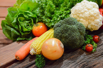 Mixed Vegetables and Salads on wooden Background.Select focus on corn.