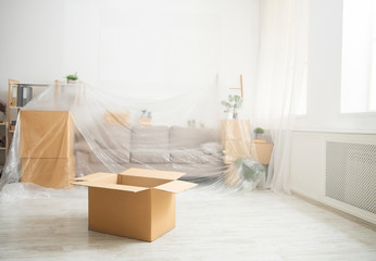 Furniture covered oilcloth and open cardboard box