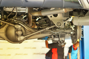 Suspension of drive car with new tire and Shock Absorber.Rear suspension of a modern car. Elements and design of the rear suspension. Rear suspension beam, spring, shock absorber.Close up.