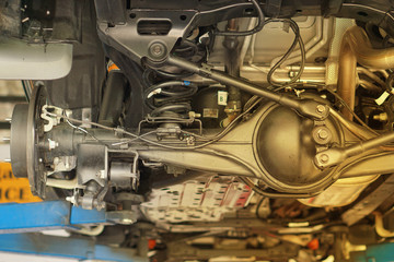 Suspension of drive car with new tire and Shock Absorber.Rear suspension of a modern car. Elements and design of the rear suspension. Rear suspension beam, spring, shock absorber.Close up.