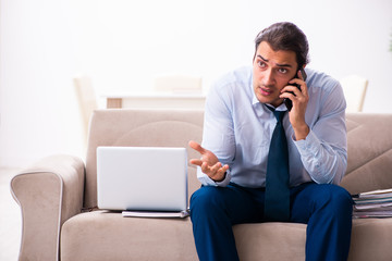 Young male employee working from house