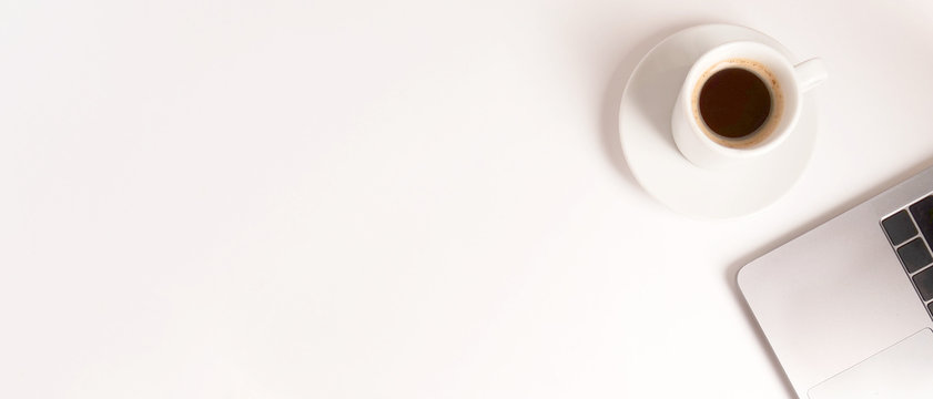 flat lay composition with laptop and coffee on white desktop. Banner. Copyspace. Concept remote study and work at home, telework, freelance, quarantine. Distance online learning. Space for text.