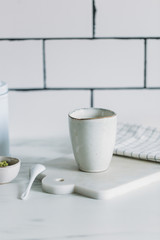 Simple rustic handmade mugs on marble table