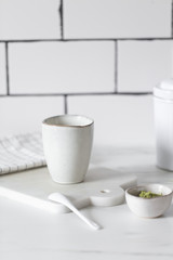 Simple rustic handmade mugs on marble table