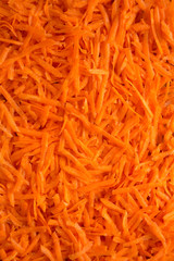 Shredded carrots background, top view. Flat lay, overhead, from above.