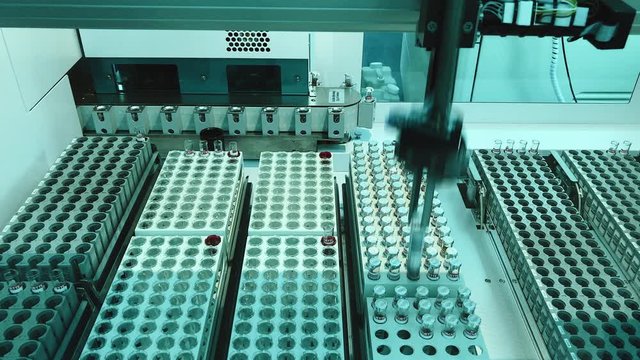 Top view of automatic blood test, medical analysis on special mechanism.Blood testing laboratory diagnostic process. Concept of health care and medicine.