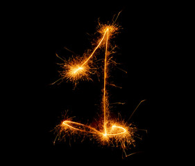 number one written with a sparkler on a black background