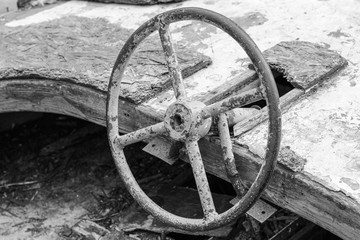 Fototapeta na wymiar Old wrecked boat on land. Black and white photo.