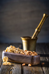 Persimmon, walnuts, cashew nuts, almonds on wooden plates