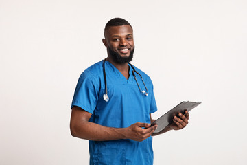 Smiling black doc in blue uniform with medical report