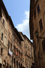 Fototapeta na wymiar Volterra (SI), Italy - April 25, 2017: Typical houses in centre of Volterra, Tuscany, Italy
